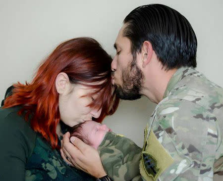 Alexandra McClintock holds her son Declan with her husband U.S. Army Sergeant First Class Matthew McCintock in this October 2015 handout photo provided May 24, 2017. Courtesy Alesandra McClintock/Handout via REUTERS