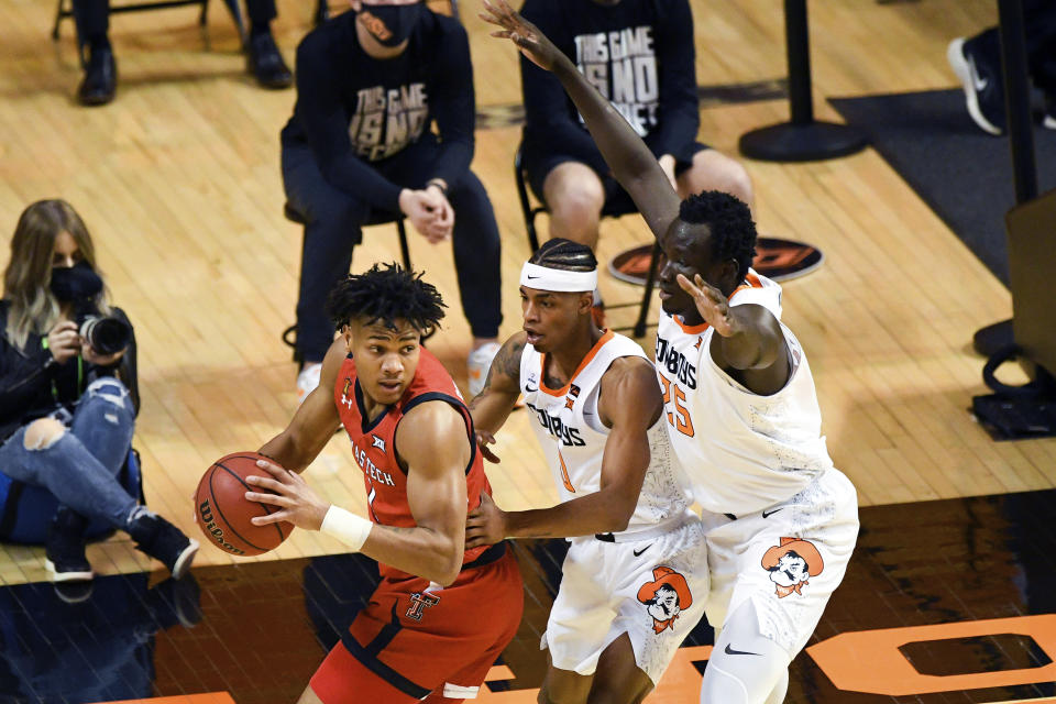 Texas Tech guard Terrence Shannon Jr., front left, looks over his shoulder at Oklahoma State guard Avery Anderson III (0) and forward Bernard Kouma (25) during an NCAA college basketball game Monday, Feb. 22, 2021, in Stillwater, Okla. (AP Photo/Brody Schmidt)