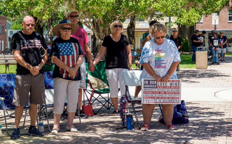 People listen as the names of mass shooting victims are read aloud during an interfaith prayer vigil held in the aftermath of recent mass shootings in Wildwood on Saturday, May 28, 2022. [PAUL RYAN / CORRESPONDENT]