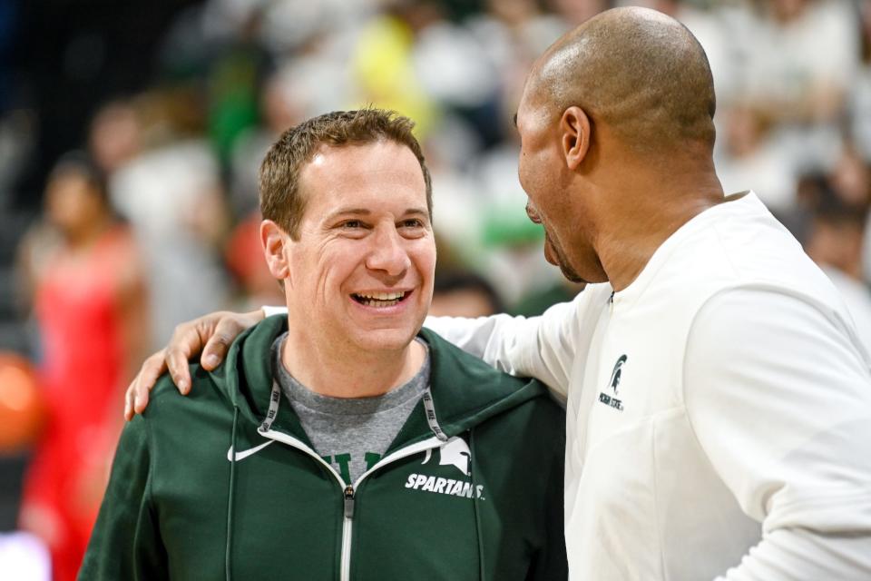 Former Michigan State player and Phoenix Suns owner Mat Ishbia, left, talks with assistant coach Thomas Kelley before the game against Ohio State on Saturday, March 4, 2023, at the Breslin Center in East Lansing.