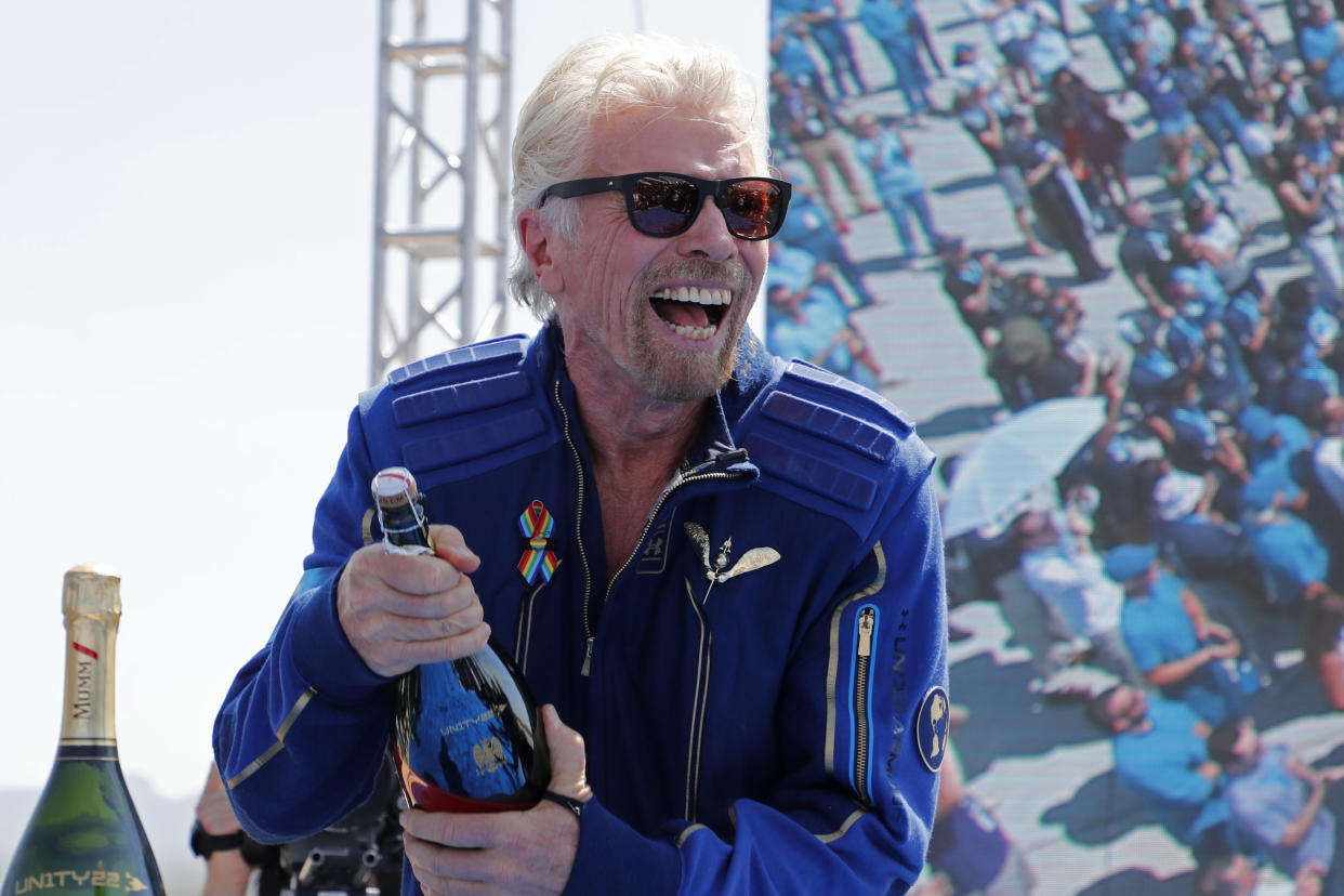 Billionaire entrepreneur Richard Branson prepares to spray champagne after flying with a crew in Virgin Galactic's passenger rocket plane VSS Unity to the edge of space at Spaceport America near Truth or Consequences, New Mexico, U.S., July 11, 2021. REUTERS/Joe Skipper