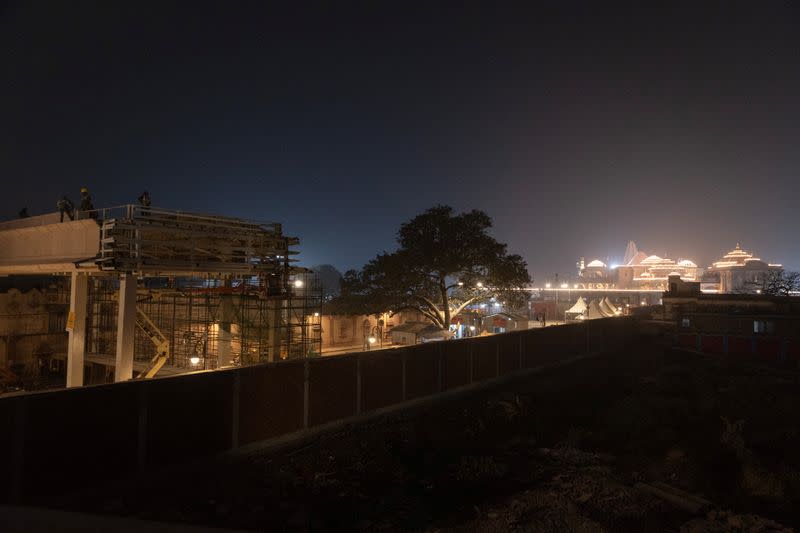 Illuminated grand temple of Lord Ram is pictured as labourers work inside the premises of the temple ahead of its opening in Ayodhya