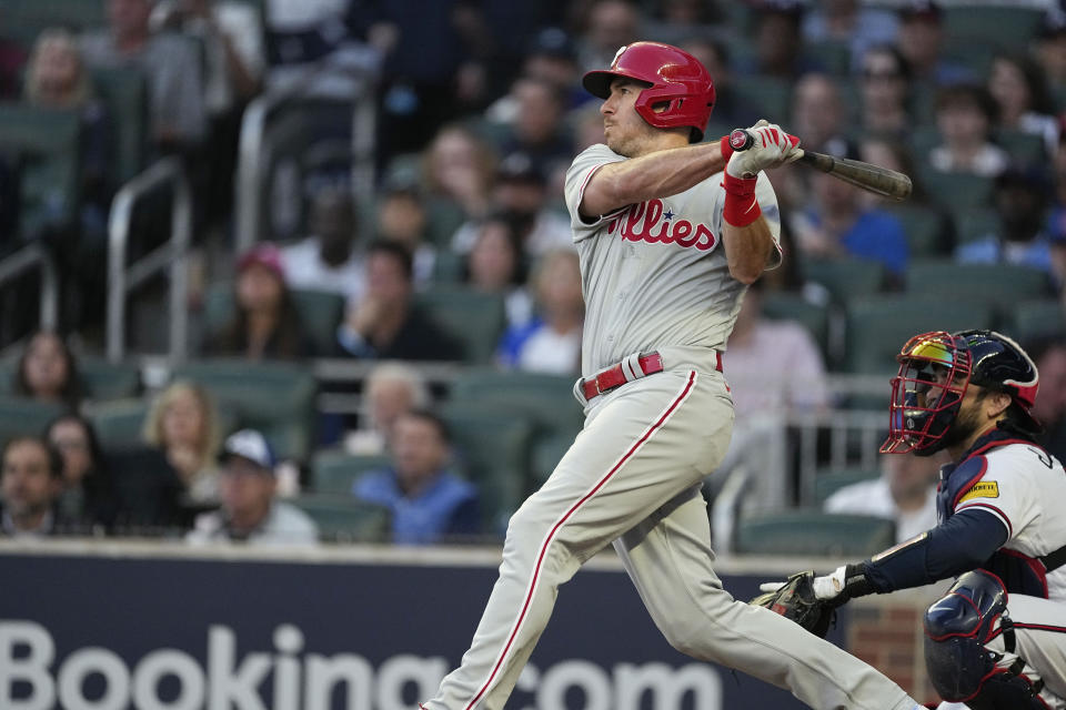 Philadelphia Phillies' J.T. Realmuto (10) hits a two-run homer in the third inning of Game 2 of a baseball NL Division Series against the Atlanta Braves, Monday, Oct. 9, 2023, in Atlanta. (AP Photo/John Bazemore)