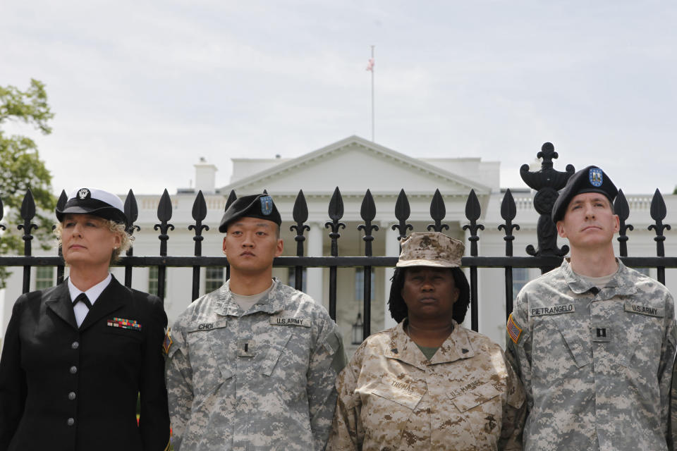 FILE - From left, Petty Officer Autumn Sandeen, Lt. Dan Choi, Cpl. Evelyn Thomas and Capt. Jim Pietrangelo II, stand outside the White House on Tuesday, April 16, 2010, after they handcuffed themselves to the fence during a protest for gay rights in Washington, demanding that President Obama keep his promise to repeal "don't ask, don't tell." On Sept. 20, 2011, the repeal of U.S. military's 18-year-old compromise policy took effect, allowing gay and lesbian service members to serve openly. (AP Photo/Pablo Martinez Monsivais, File)