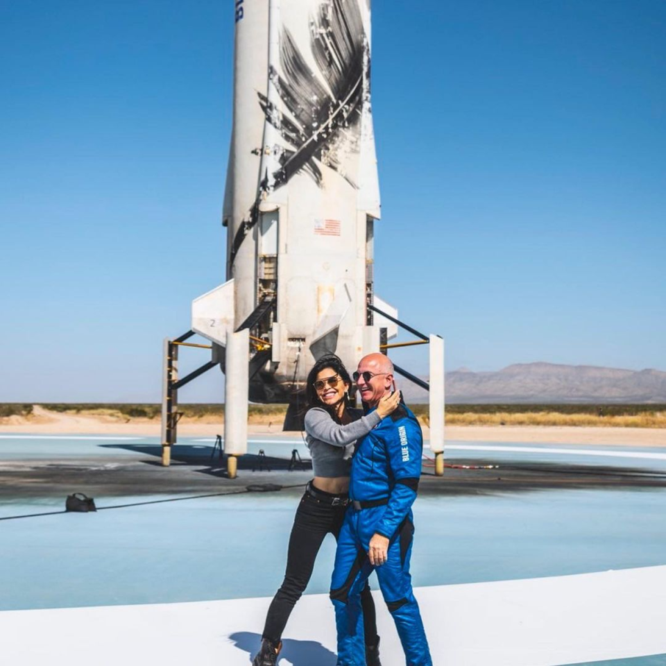 Sánchez and Bezos pose with a Blue Origin rocket (@laurenwsanchez/Instagram)