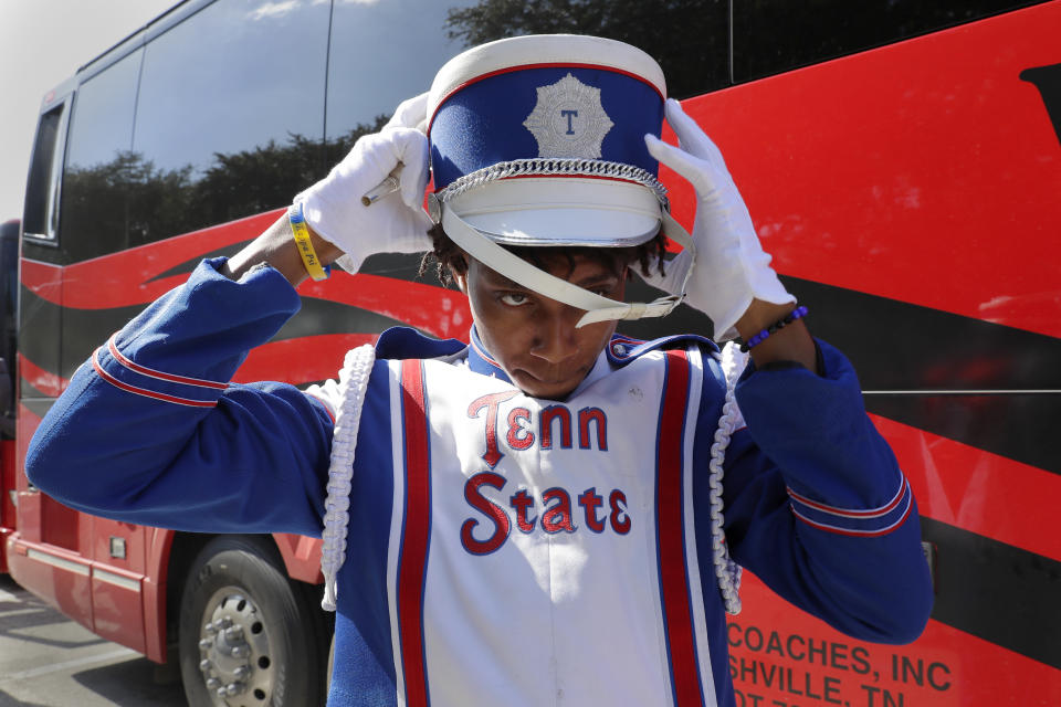 Decarlos Street, a trombone player with the Tennessee State University Aristocrat of Bands marching band, puts on his hat as the band gets ready to enter the venue from their buses for the 2023 National Battle of the Bands, a showcase for HBCU marching bands, held at NRG Stadium, Saturday, Aug. 26, 2023, in Houston. (AP Photo/Michael Wyke)