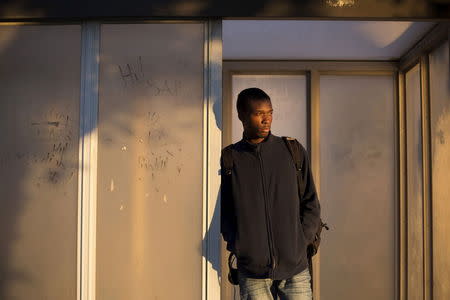 Donte Walker, 21, poses for a photograph at a bus stop outside his residence in Poughkeepsie, New York, October 5, 2014. Walker says he was the age of 16 through 18 years-old when he was detained and served time on Rikers Island from 2010 to 2012 for assault, possession of firearm and armed robbery. After one altercation with another inmate, Walker says he was put in flexicuffs and punched "Mad hard, like real hard" in the face by a correctional officer. When asked if he reported the incident he said, "Cause who you report it to? You gonna report it to another CO (correctional officer) which he's cool with. He probably eats lunch with everyday. And he's gonna tell him and now they gonna whoop your ass even more." Rikers, one of the largest jail complexes in the country which houses around 9,800 prisoners, came under scrutiny after the Justice Department in August 2014 issued a report that described a pattern of violent abuse of male inmates aged 16 to 18 by jail staff. In response to questions from Reuters, a spokesman for Rikers Island Department of Correction (DOC) said that, "Since Commissioner (Joseph) Ponte's appointment last year, he has significantly reformed the care and custody of adolescent inmates, resulting in substantial decline in violence in the adolescent facility." The spokesman added that safety for staff and inmates is Commissioner Ponte's "top priority" and that "DOC has a zero-tolerance police with regards to abuse." Reuters has been unable to independently verify the statements provided by the individual in this portrait. Picture taken October 5, 2014. REUTERS/Elizabeth Shafiroff