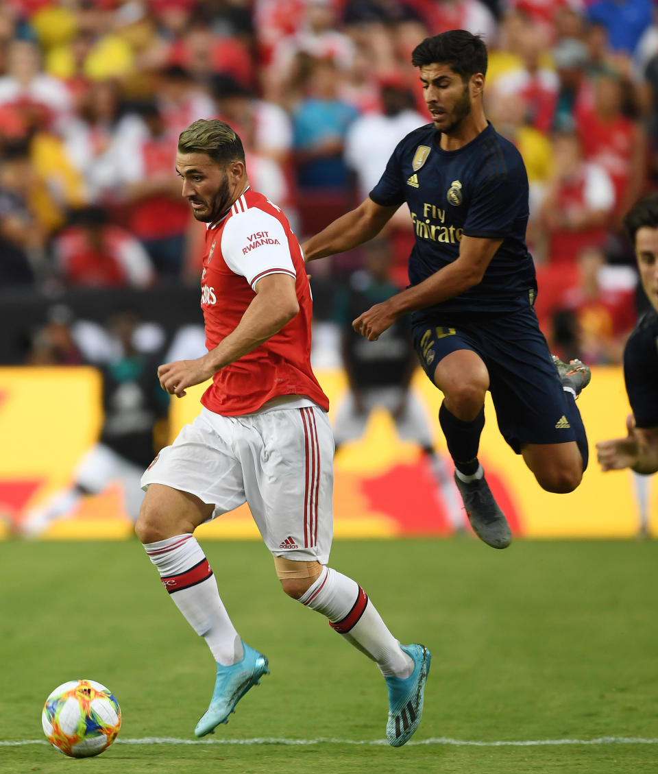 LANDOVER, MARYLAND - JULY 23: Sead Kolasinac of Arsenal breaks past Marco Asensio of Real Madrid during the International Champions Cup match between Real Madrid and Arsenal at FedExField on July 23, 2019 in Landover, Maryland. (Photo by Stuart MacFarlane/Arsenal FC via Getty Images)