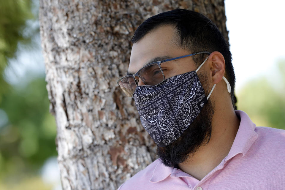 Henry Montalvo, 30, poses for a photo Wednesday, July 15, 2020, in Phoenix. Montalvo was furloughed in March and his federal unemployment benefit expires later this month. (AP Photo/Matt York)