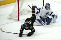 Arizona Coyotes right wing Conor Garland (83) flips over Tampa Bay Lightning goaltender Andrei Vasilevskiy, right, during the second period of an NHL hockey game Saturday, Feb. 22, 2020, in Glendale, Ariz. (AP Photo/Ross D. Franklin)