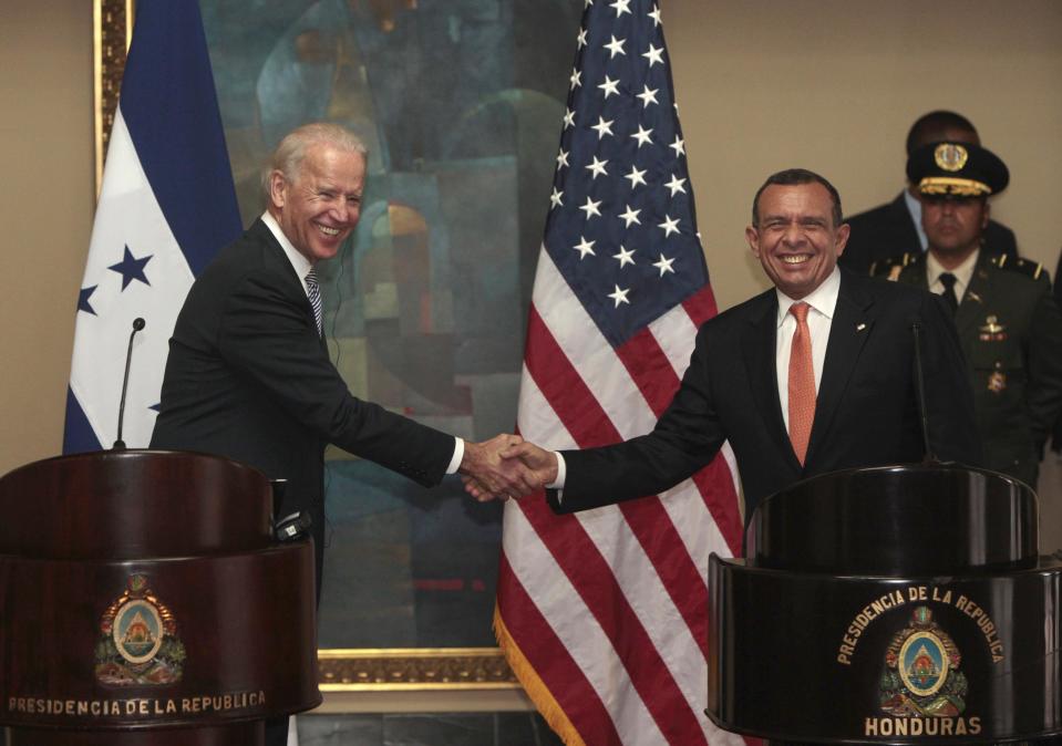 U.S. Vice President Joe Biden, left, and Honduras' President Porfirio Lobo shake hands as they pose for pictures during a meeting at the presidential house in Tegucigalpa, Honduras, Tuesday, March, 6, 2012. Biden is on a one-day visit to Honduras. (AP Photo/Esteban Felix)