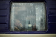 A man, fleeing from heavy shelling, cries as he sits inside an evacuation train to depart Pokrovsk train station, in Pokrovsk, eastern Ukraine, Sunday, May 22, 2022. Civilians fleeing areas near the eastern front in the war in Ukraine Sunday described scenes of devastation as their towns and villages came under sustained attack from Russian forces. (AP Photo/Francisco Seco)