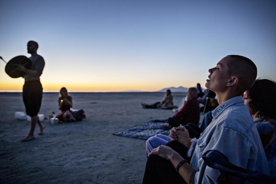 Tess Huntington, far right, and other Divine Assembly members participate in breath work exercises at the Great Salt Lake in June. “You eat some fungus and it’s like hitting the jackpot,” Huntington says. - Credit: Kim Raff for Rolling Stone