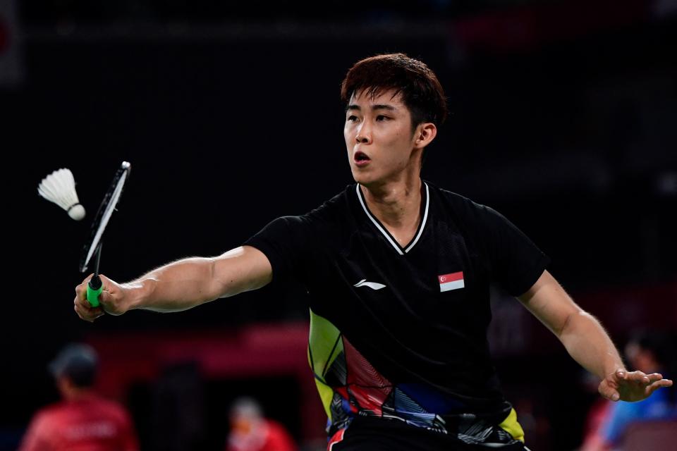 Singapore shuttler Loh Kean Yew in action against the Refugee Olympic Team's Aram Mahmoud in their men's singles badminton group stage match at the Tokyo Olympics.