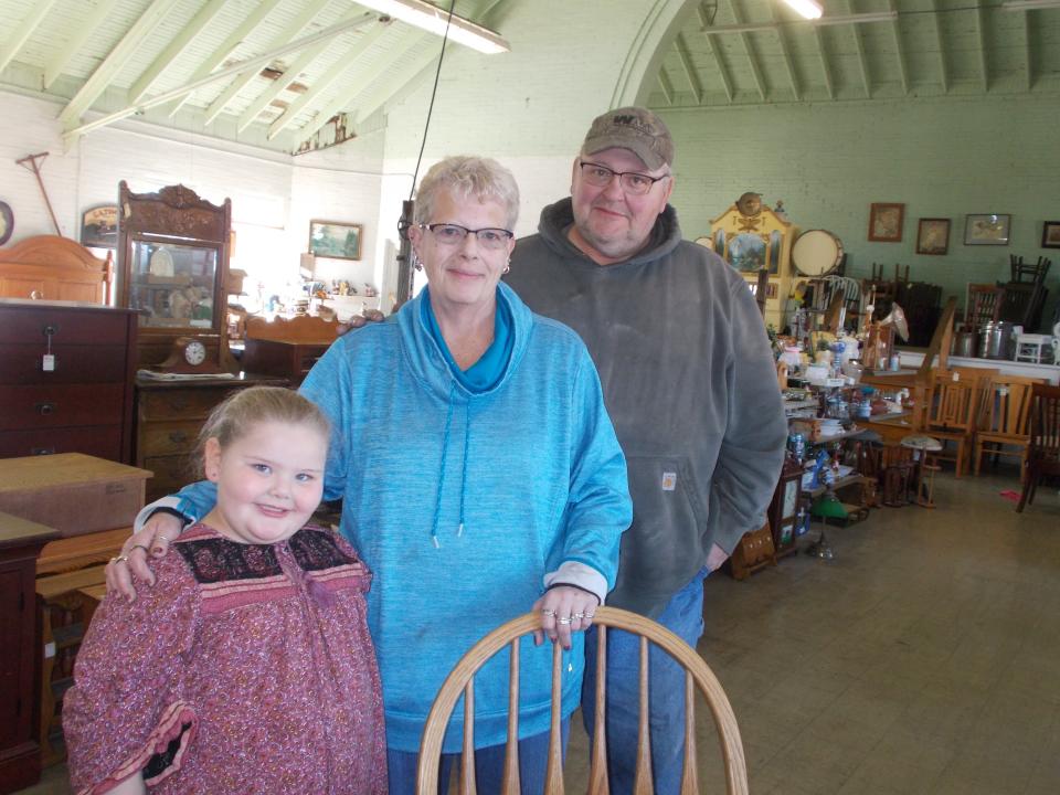 Valerie and Dan Durbin stand with granddaughter Annalisa Durbin in the Erlin Trader shop  in Clyde.