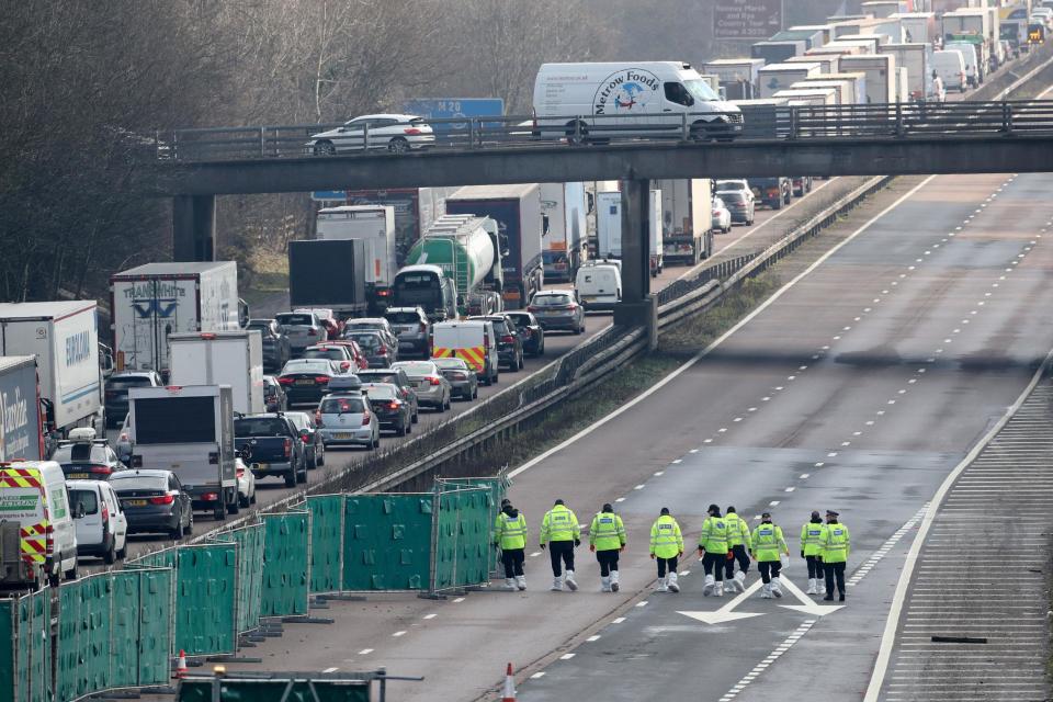 Police officers at work on the M20 near Ashford in Kent: PA