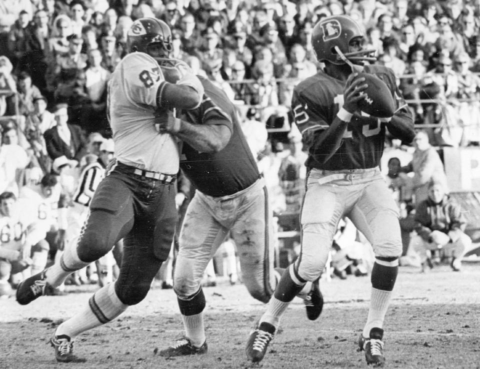 Denver quarterback Marlin Briscoe looks to make a pass in the first quarter of an NFL football game against the Kansas City Chiefs in Denver on December 14, 1968. Marlin Briscoe, the first quarterback black starter in the American Football League, died Monday, June 6.  27, 2022.