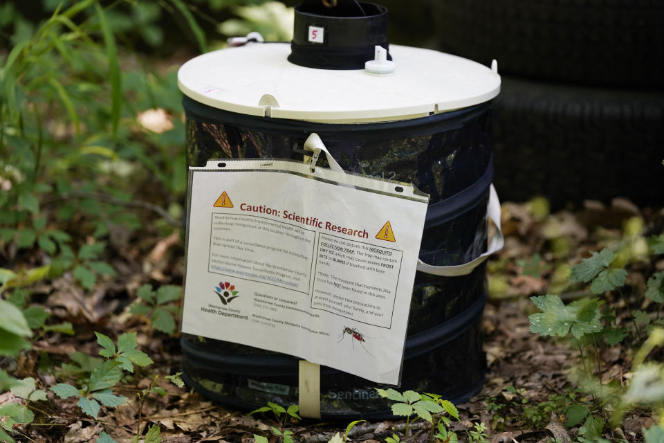 A mosquito trap, placed by the Washtenaw County health department sits Thursday, July 14, 2022, in Ann Arbor Township, Mich. As climate change widens the insect's range and lengthens its prime season, more Americans are resorting to the booming industry of professional extermination. But the chemical bombardment worries scientists who fear over-use of pesticides is harming pollinators and worsening a growing threat to birds that eat insects. (AP Photo/Carlos Osorio)