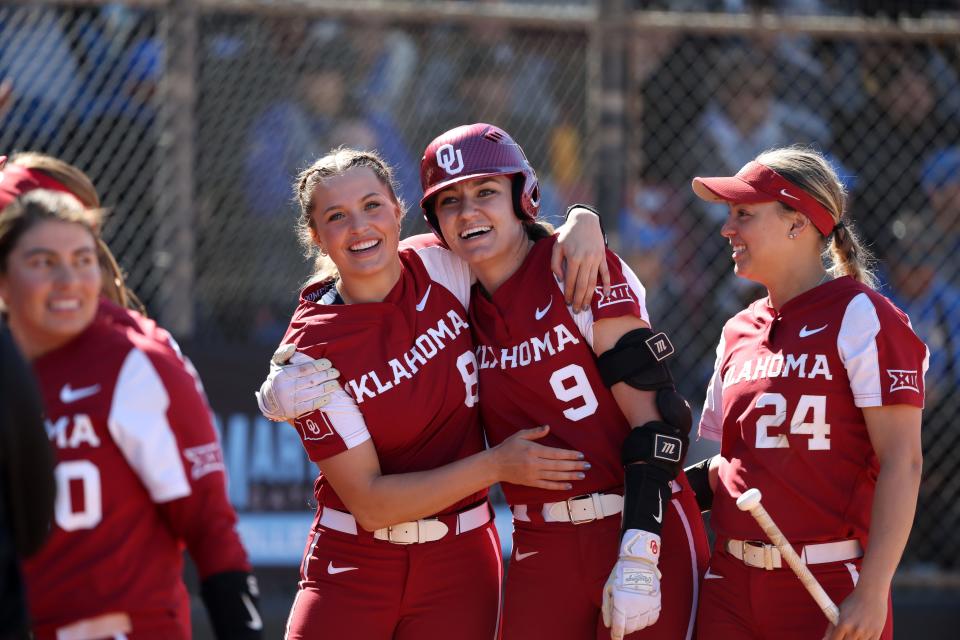 OU pitcher Alex Storako (8) hugs catcher Kinzie Hansen (9) during a 14-0 win against UCLA last year in Cathedral City, Calif.