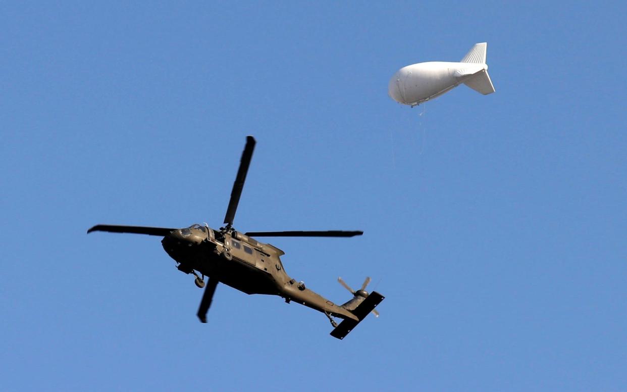 A NATO helicopter flies over the Resolute Support headquarters in Kabul - REUTERS