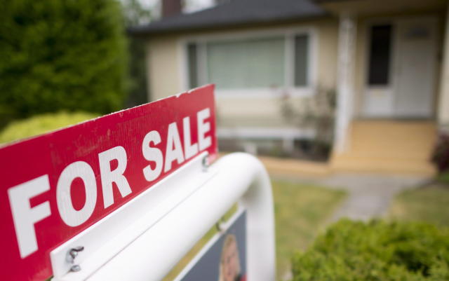 A real estate sign is pictured in Vancouver, B.C., Tuesday, June 12, 2018. A report by Royal LePage says the median price of a home in Canada in the fourth quarter of 2022 posted the first year-over-year decline since the end of 2008 during the financial crisis. THE CANADIAN PRESS Jonathan Hayward