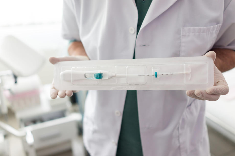 Doctor in hospital holding IUD