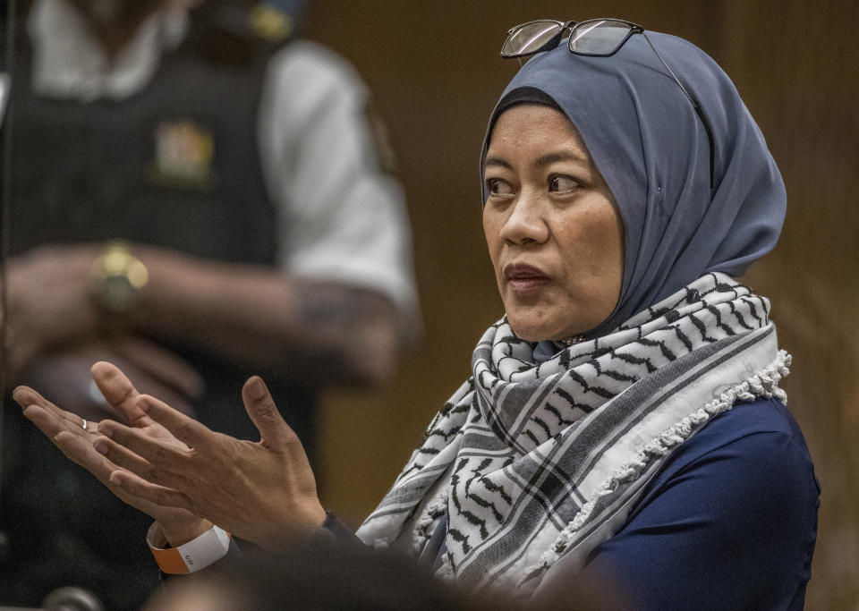 Hamimah Tuyan gestures as she gives her victim impact statement during the sentencing hearing for Australian Brenton Harrison Tarrant at the Christchurch High Court after Tarrant pleaded guilty to 51 counts of murder, 40 counts of attempted murder and one count of terrorism in Christchurch, New Zealand, Wednesday, Aug. 26, 2020. More than 60 survivors and family members will confront the New Zealand mosque gunman this week when he appears in court to be sentenced for his crimes in the worst atrocity in the nation's modern history. (John Kirk-Anderson/Pool Photo via AP)