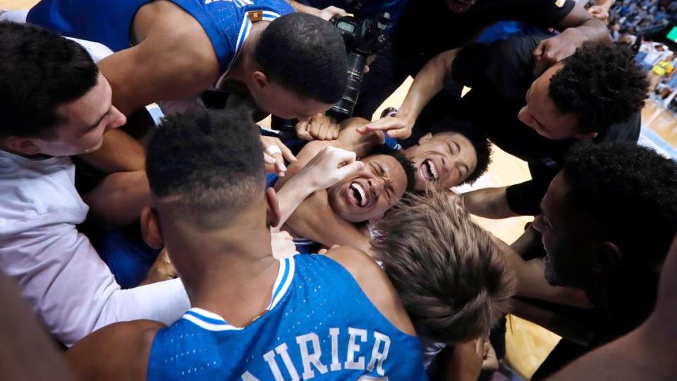 Duke’s Wendell Moore Jr. (0) is surrounded by teammates after Duke’s 98-96 overtime victory over UNC at the Smith Center in Chapel Hill, N.C., Saturday, Feb. 8, 2020.