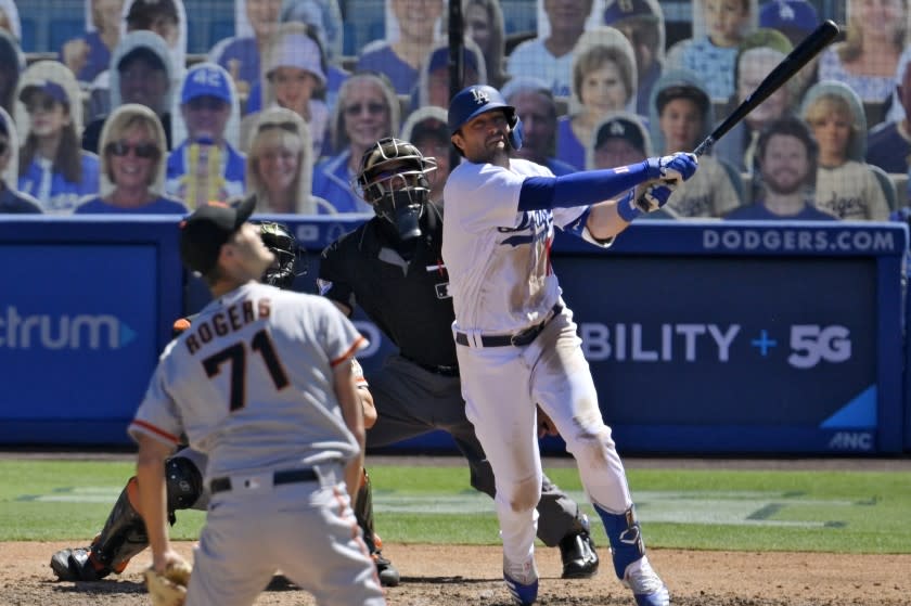 Los Angeles Dodgers' AJ Pollock watches his three-run home run off San Francisco Giants relief pitcher Tyler Rogers.