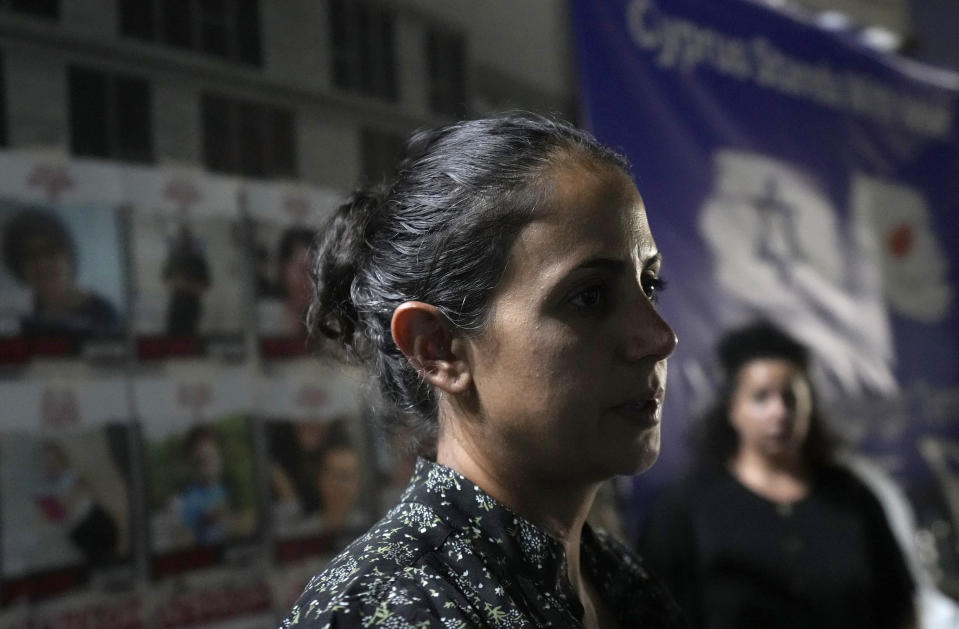 Ofri Bibas, foreground, whose brother and his family including his two children aged 4 and nine months have disappeared from their home in Israel, takes part in a support rally outside the Jewish central Synagogue in the coastal town of Larnaca, Cyprus, on Tuesday, Oct. 17, 2023. Relatives of Israelis who are missing and believed abducted by Hamas attackers during the militant group's Oct. 7 raid into southern Israel appealed to world leaders to intercede in hopes that their loved ones are returned safely. (AP Photo/Petros Karadjias)