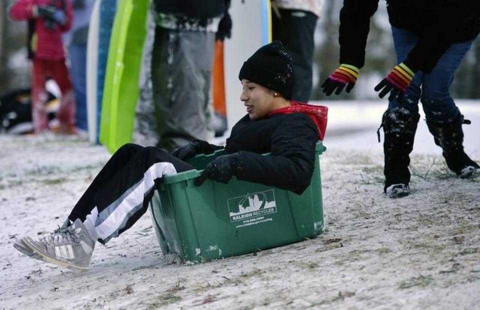 Victor Zavala, 15, uses an abandoned Raleigh recycling bin as an improvised sled at Dix Hill in Raleigh, NC Wednesday afternoon, January 29, 2014.