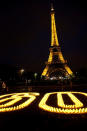 Earth Hour 2010. Candles forming 60 for Earth Hour near the Eiffel Tour, Paris, France. <br> <a href="http://www.worldwildlife.org/sites/earthhour/index.html" rel="nofollow noopener" target="_blank" data-ylk="slk:For more information about Earth Hour 2012, visit WWF.;elm:context_link;itc:0;sec:content-canvas" class="link ">For more information about Earth Hour 2012, visit WWF.</a>