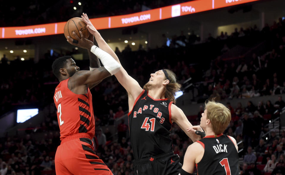 Toronto Raptors forward Kelly Olynyk (41) blocks the shot of Portland Trail Blazers center Deandre Ayton (2) as guard Gradey Dick (1) looks on during the first half of an NBA basketball game in Portland, Ore., Saturday, March 9, 2024. (AP Photo/Steve Dykes)