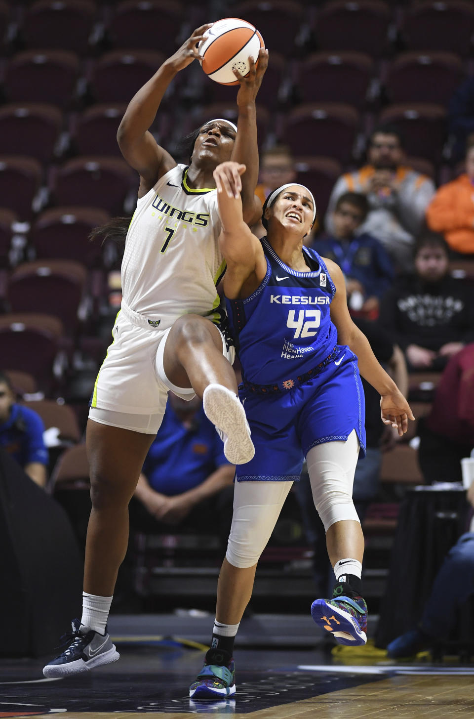 Connecticut Sun center Brionna Jones (42) fouls Dallas Wings center Teaira McCowan (7) during the first half of a WNBA basketball game Tuesday, May 24, 2022 at Mohegan Sun Arena in Uncasville, Conn. (Sean D. Elliot/The Day via AP)