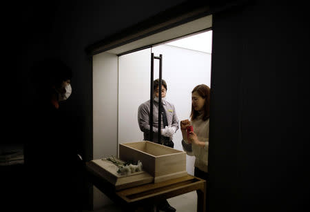 A woman cries as she bids the last farewell to her pet dog before its cremation at a pet funeral service company in Gwangju, South Korea, January 16, 2019. REUTERS/Kim Hong-Ji