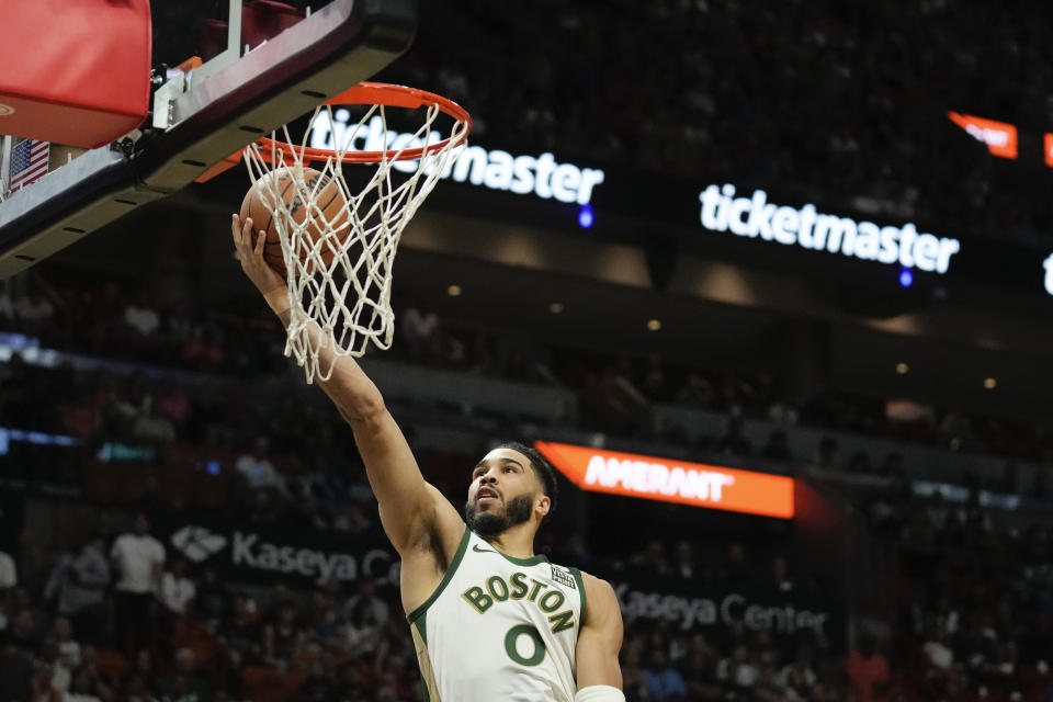 Boston Celtics forward Jayson Tatum makes a basket during the first half of an NBA basketball game against the Miami Heat, Sunday, Feb. 11, 2024, in Miami. (AP Photo/Rebecca Blackwell)