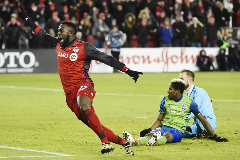 Toronto FC forward Jozy Altidore (17) celebrates after scoring against Seattle Sounders goalkeeper Stefan Frei, right, as defender Joevin Jones looks on during second-half MLS Cup final soccer action in Toronto, Saturday, Dec. 9, 2017. (Nathan Denette/The Canadian Press via AP)