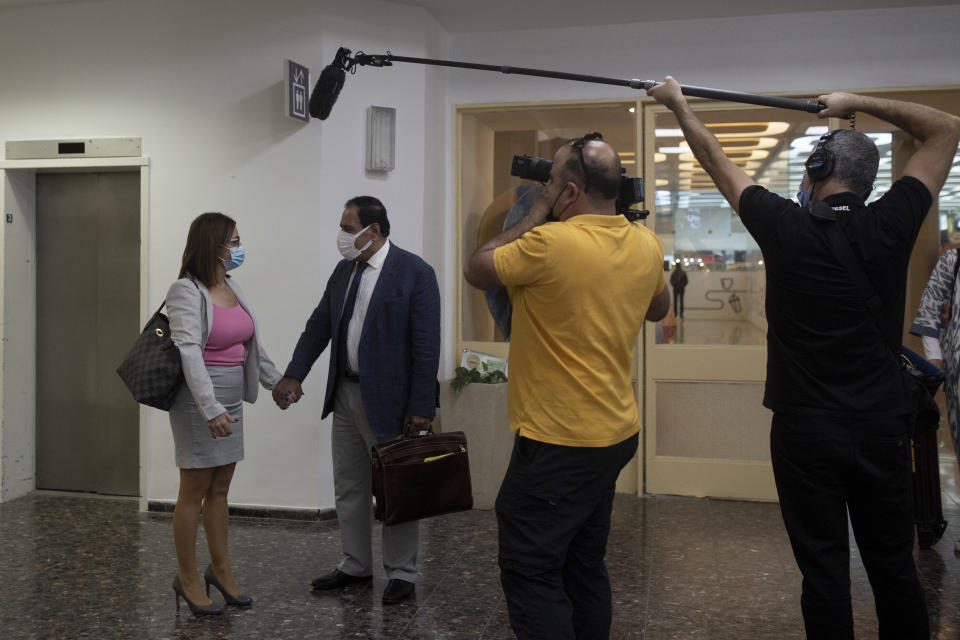 Izzeldin Abuelaish, second left, is welcomed by Vice President Mona Khoury-Kassabri as a Canadian documentary crew films them while touring Hebrew University in Jerusalem on Thursday, Nov. 11, 2021. For 13 years, the man known in Israel as "the Gaza doctor" has waged a battle through the Israeli courts and the public to remember and deliver justice to his daughters Aya, 13, Bessan, 21, Mayar, 15, and his niece Noor, 17, all killed by an Israeli missile in their bedroom on January 16, 2009. On Monday, Nov. 15, Israel's Supreme Court will hear Abuelaish's demand for an apology and compensation. (AP Photo/Maya Alleruzzo)