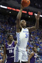 Kentucky's Oscar Tshiebwe (34) shoots near High Point's Emmanuel Izunabor (10) during the first half of an NCAA college basketball game in Lexington, Ky., Friday, Dec. 31, 2021. (AP Photo/James Crisp)