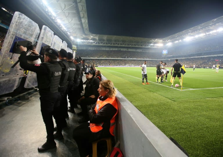 Riot police had to protect players from objects being thrown from the stands during the bad-tempered Cup tie between Fenerbahce and Besiktas