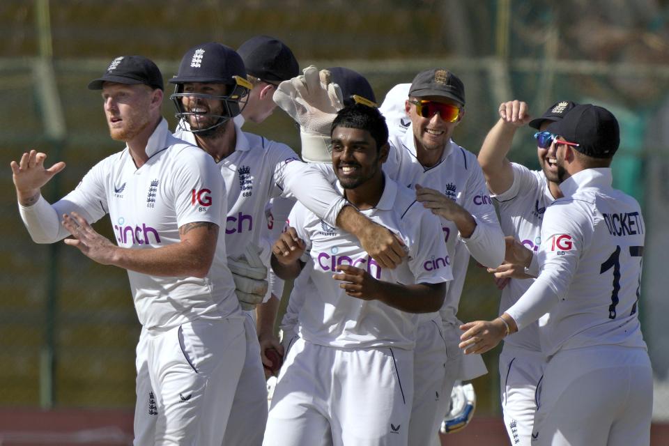 England's Rehan Ahmed, center, celebrates with teammates after taking the wicket of Pakistan's Saud Shakeel during the first day of third test cricket match between England and Pakistan, in Karachi, Pakistan, Saturday, Dec. 17, 2022. (AP Photo/Fareed Khan)