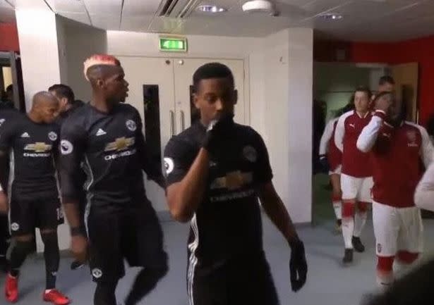 Paul Pogba locked onto Mesut Ozil