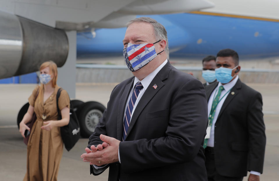 U.S. Secretary of State Mike Pompeo walks to board an aircraft to leave for Maldives, in Colombo, Sri Lanka, Wednesday, Oct. 28, 2020. Pompeo plans to press Sri Lanka to push back against Chinese assertiveness, which U.S. officials complain is highlighted by predatory lending and development projects that benefit China more than the presumed recipients. The Chinese Embassy in Sri Lanka denounced Pompeo's visit to the island even before he arrived there, denouncing a senior U.S. official's warning that the country should be wary of Chinese investment. (AP Photo/Eranga Jayawardena, Pool)