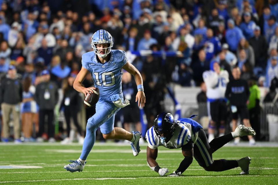 Nov 11, 2023; Chapel Hill, North Carolina, USA; North Carolina Tar Heels quarterback Drake Maye (10) looks to pass as Duke Blue Devils linebacker Tre Freeman (12) defends in the first overtime at Kenan Memorial Stadium. Mandatory Credit: Bob Donnan-USA TODAY Sports