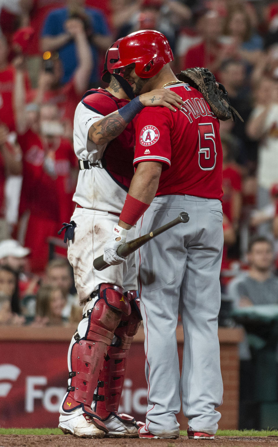 St. Louis Cardinals catcher Yadier Molina, left, hugs his former teammate Los Angeles Angels' Albert Pujols, right, after Pujols' last at bat of the night during the ninth inning of a baseball game, Sunday, June 23, 2019, in St. Louis. (AP Photo/L.G. Patterson)