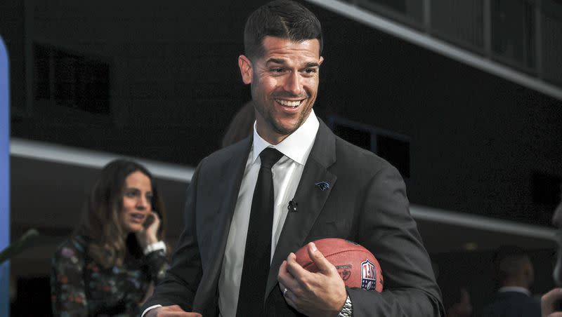 Dave Canales holds a football after a press conference introducing him as the new head coach for the Carolina Panthers in Charlotte, N.C., Thursday, Feb. 1, 2024.