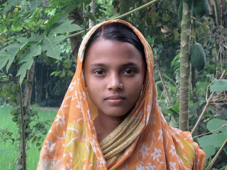 Rina Begum, 14, stands outside her parents' home, in Jamalpur, Bangladesh. Rima, whose education was cut short at Grade 6, was taken out of school to marry. Her husband beats her and has sent her back to her parents.