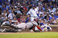 Cincinnati Reds catcher Tyler Stephenson, left, tags out Chicago Cubs' Rafael Ortega at home during the third inning of a baseball game Tuesday, July 27, 2021, in Chicago. (AP Photo/David Banks)