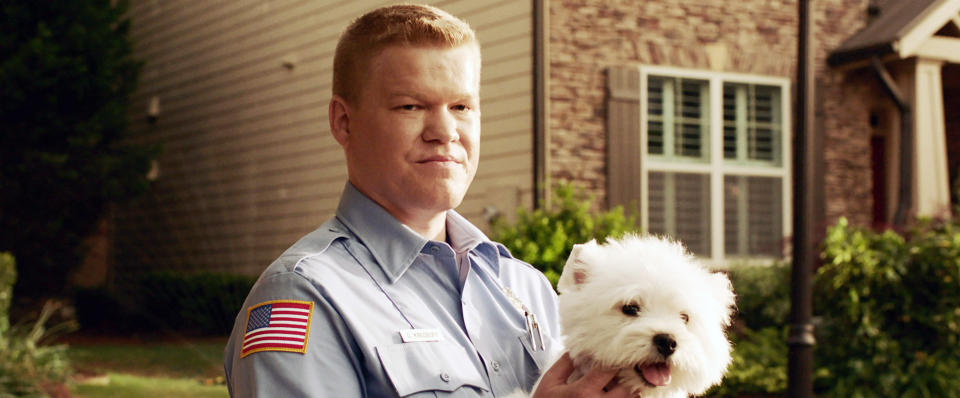 Jesse Plemons holding a dog