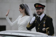 Jordan's Crown Prince Hussein and Saudi Rajwa Alseif wave to well-wishers during their wedding ceremonies in Amman, Jordan, Thursday, June 1, 2023. (AP Photo/Nasser Nasser)